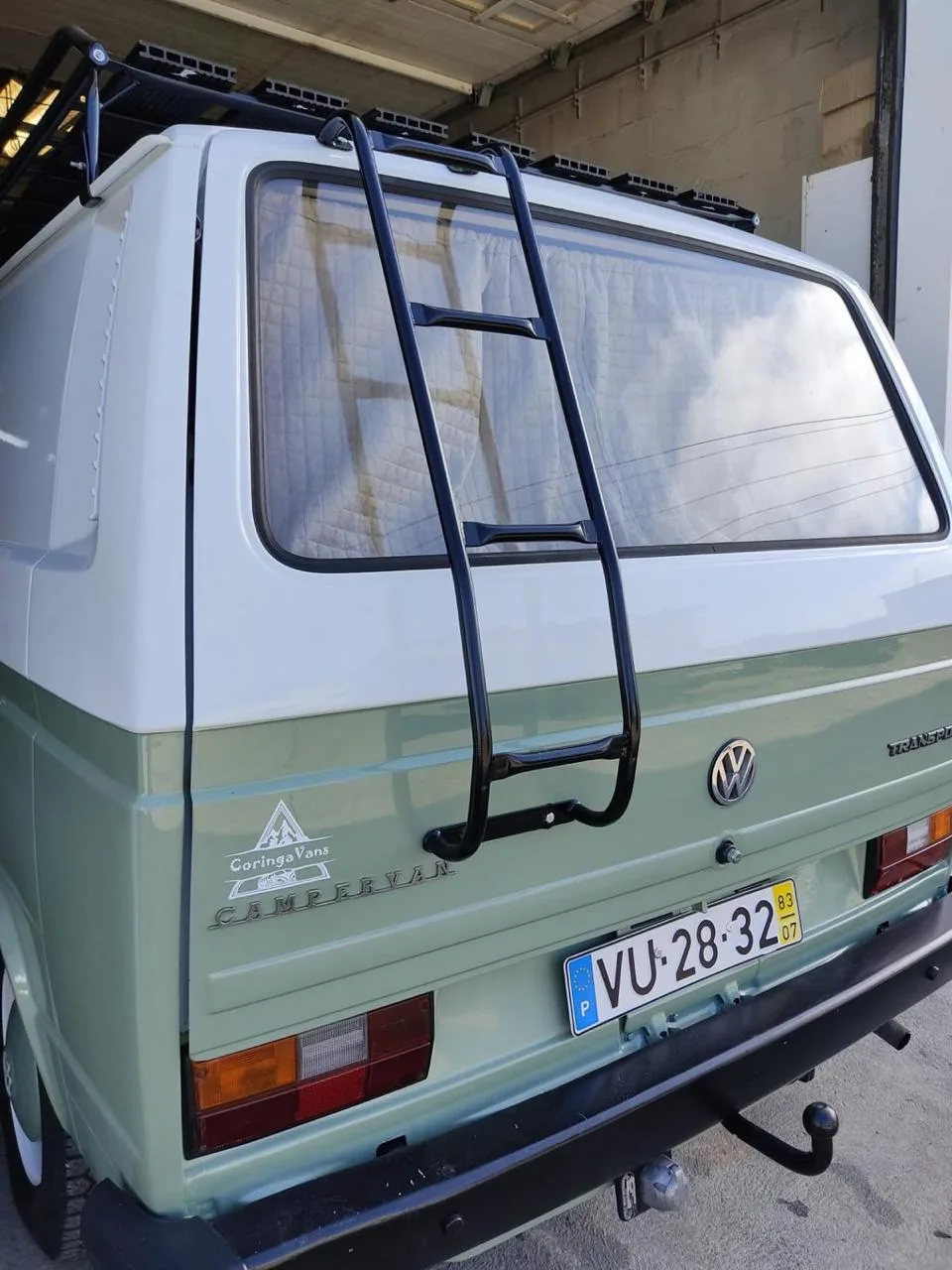 T3 rear view with ladder and roof rack, Coringa Vans branding on the tailgate