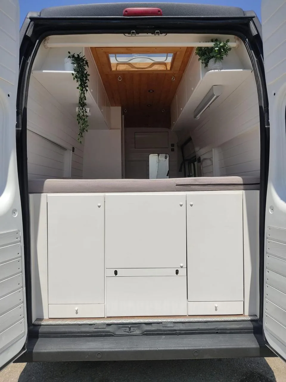Front view of the interior through the rear doors, white cabinetry
