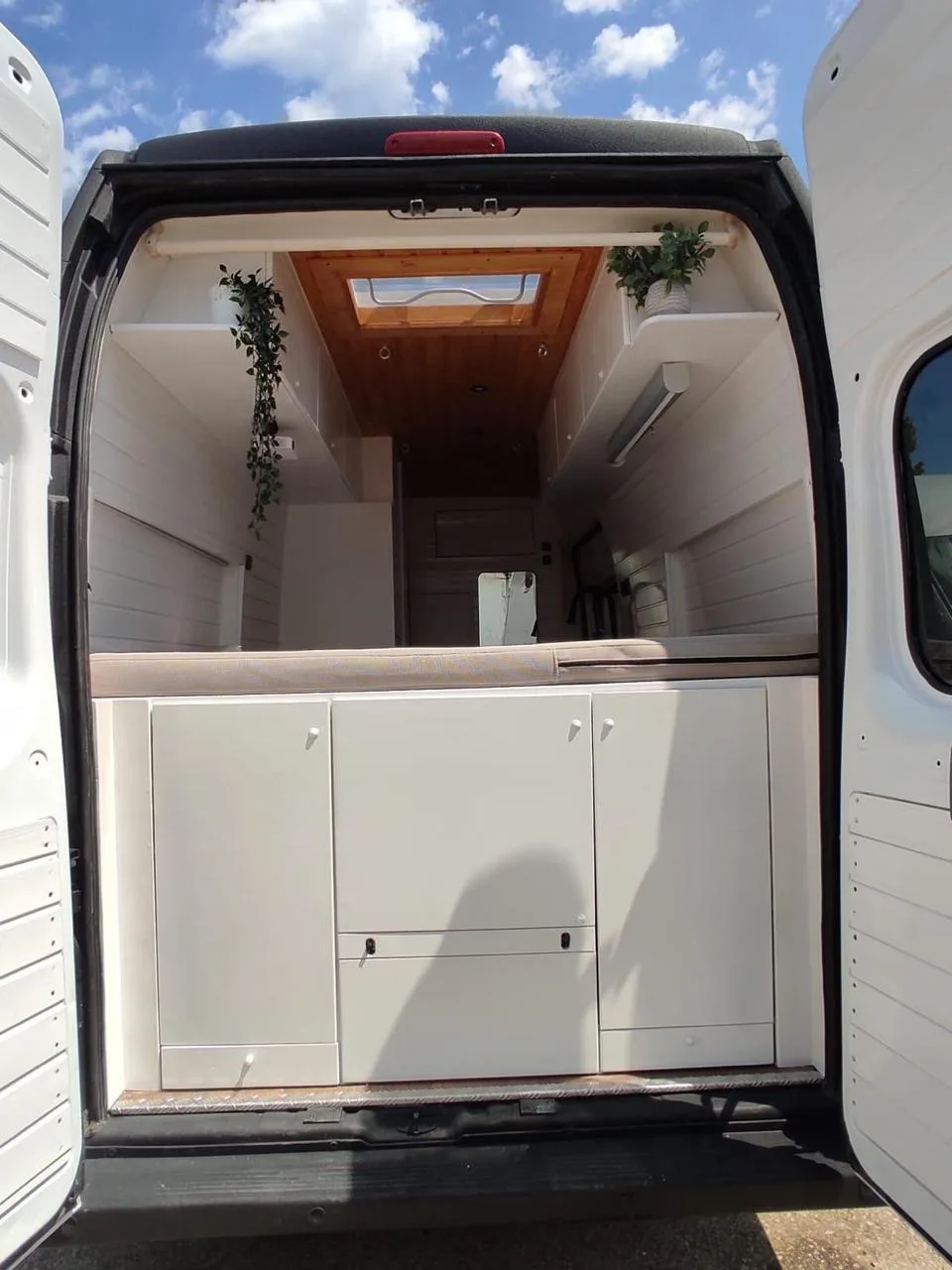 Jumper interior with white cabinetry and light-wood ceiling