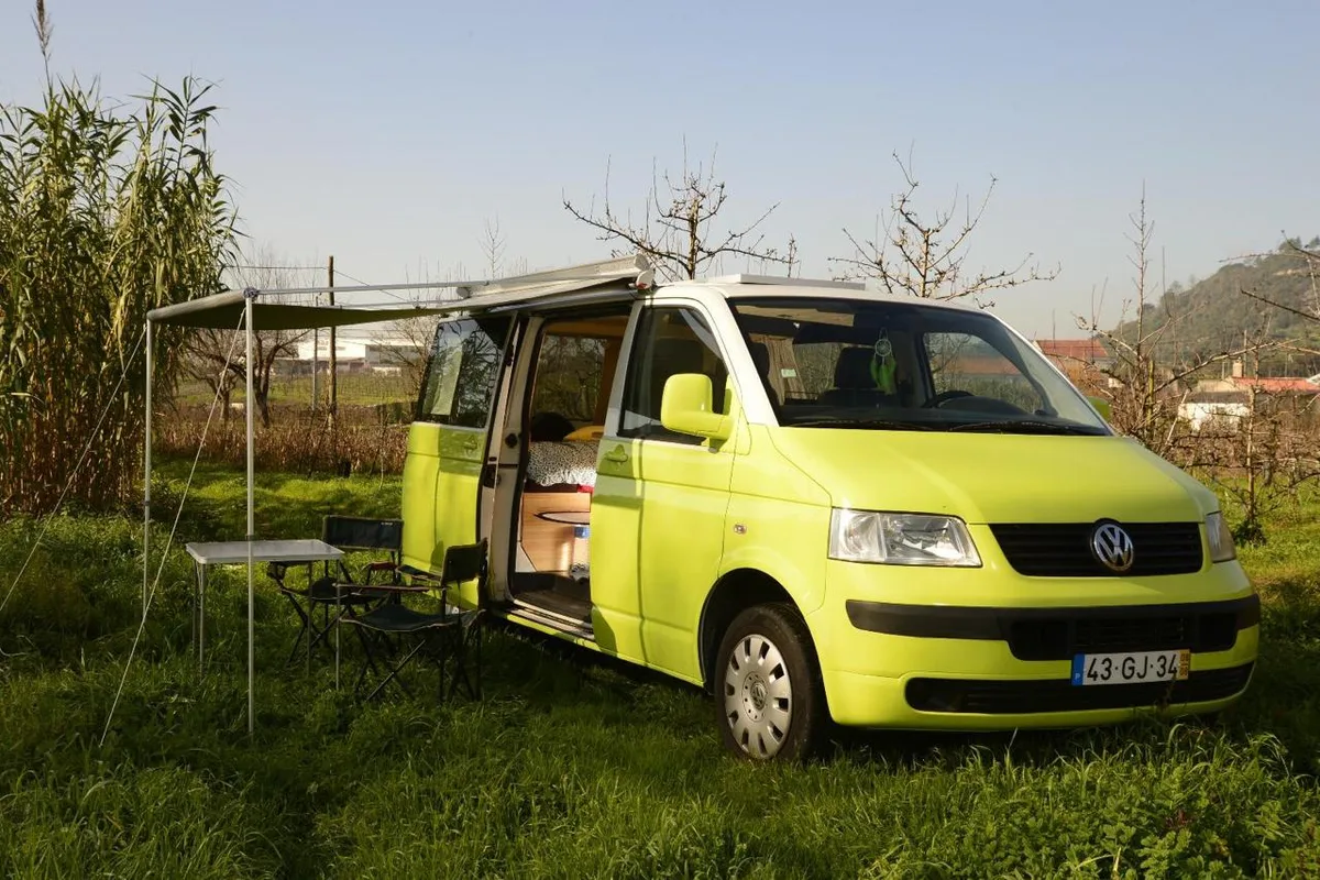 Side view with open awning in a green setting