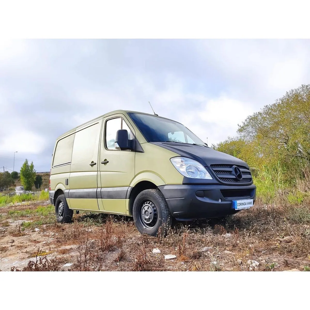 Front view of military green Sprinter with Coringa Vans logo