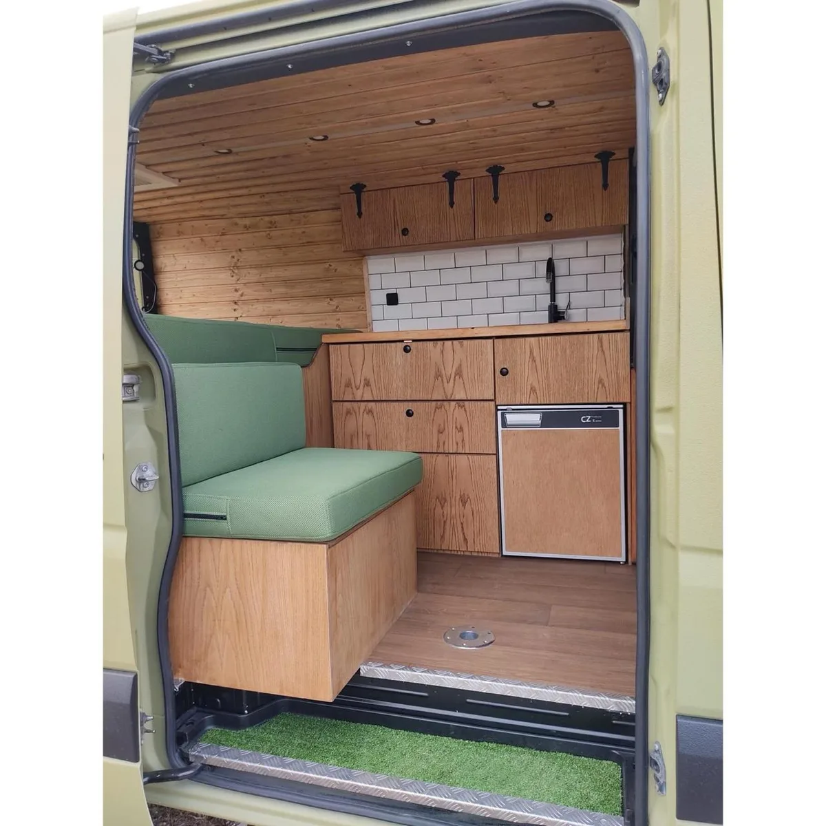 Side door interior — seat and kitchen with subway tiles
